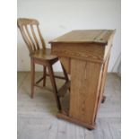 Victorian pine raised clerks desk with sloped hinged top above single panelled door cupboard to