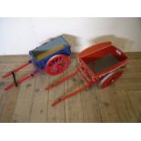 Two large handmade wooden models of horse drawn carts