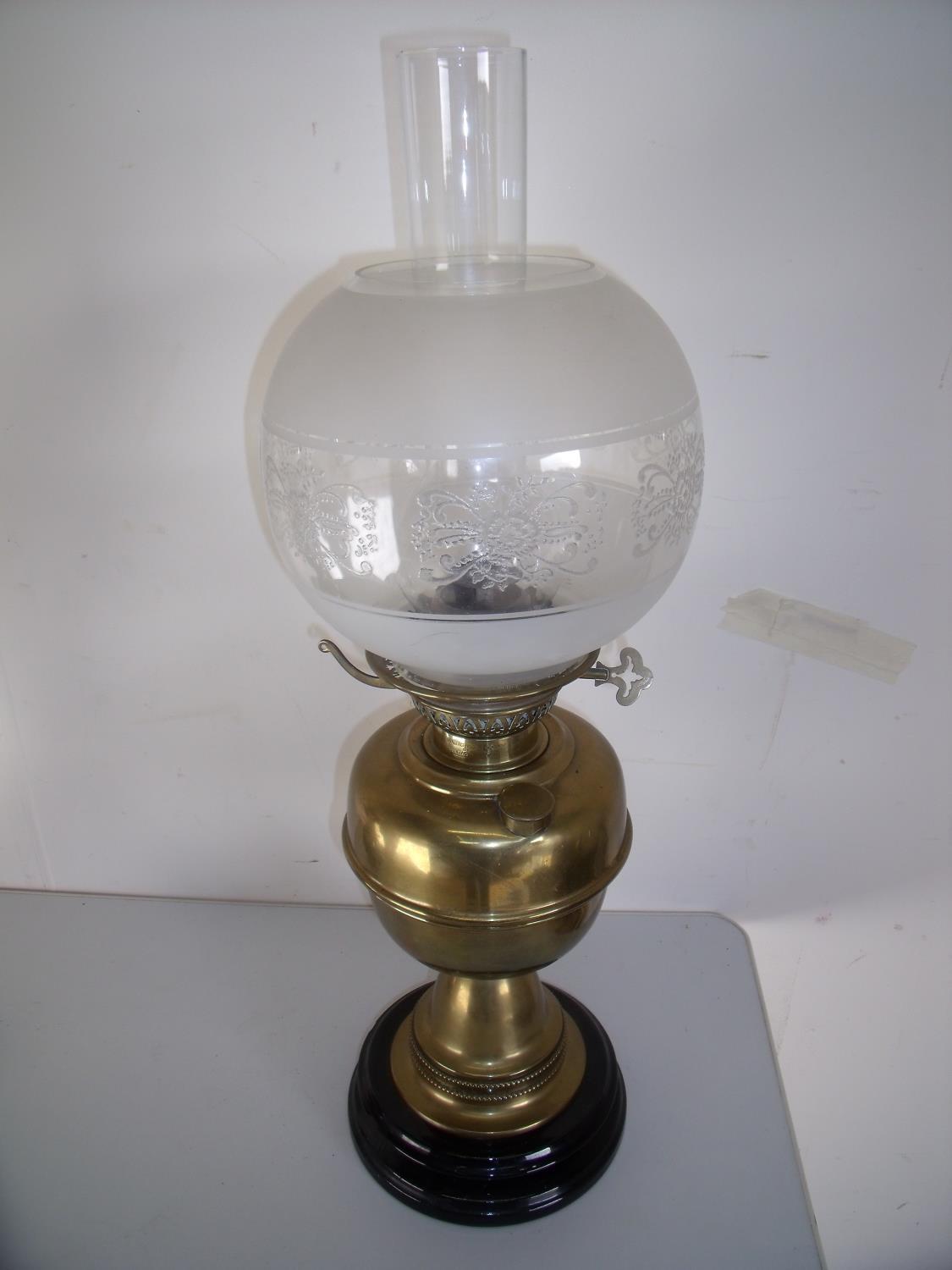 Early 20th brass oil lamp on turned base with etched glass shade