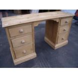 Waxed pine twin pedestal kneehole dressing chest with three drawers to each pedestal, with raised