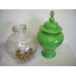 Large green pottery table lamp (46cm high) and a small glass carboy with pebble decoration