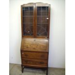 1930s oak bureau bookcase with lead glazed doors above fall front and two drawers (width 75cm)