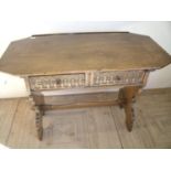 Quality oak reproduction style two drawer side table with shaped top above two carved drawers and