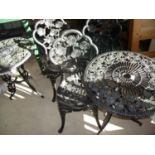 Set of three cast metal garden chairs with rose decoration and two matching garden tables