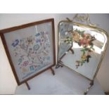 Brass framed bevel edged mirrored fire screen and an oak framed fire screen with needlework panel (