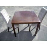 Modern mahogany square dining table on square supports and two upholstered chairs