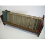 1920/30s oak book trough (width 65cm) with a selection of various books including the works of