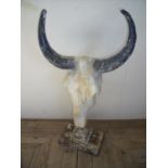 Composite style wildebeest skull on rectangular base stand (87cm high)