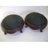 Pair of Victorian carved walnut circular footstools with upholstered tops