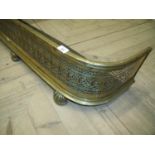 Late 19th C brass fretwork D shaped fire fender on raised supports (width 114cm)