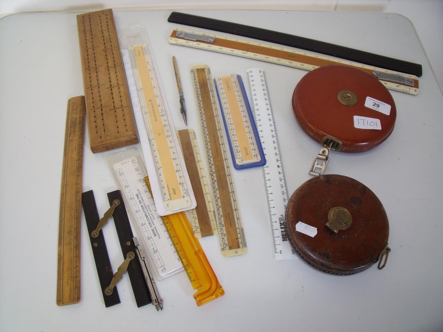 Two leather cased tapes, various rulers and measuring devices