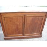 Late Victorian mahogany side cabinet enclosed by two panelled doors with adjustable shelved interior