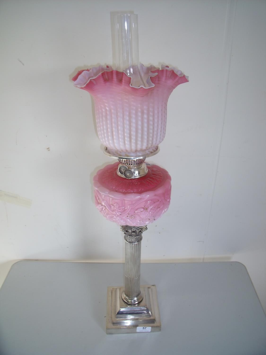 Late Victorian oil lamp with silver plated Corinthian column base with pink glass reservoir and
