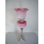 Late Victorian oil lamp with silver plated Corinthian column base with pink glass reservoir and