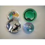 Four glass paperweights including Caithness