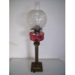 19th/20th C brass Corinthian column oil lamp with cranberry glass reservoir etched glass shade on