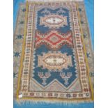 Persian type hand knotted blue ground rug with yellow border (196cm x 105cm)