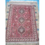 Persian type heavy woven hand knotted red ground rug (152cm x 107cm)