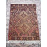 Small red ground hand knotted Persian type rug (124cm x 86cm)