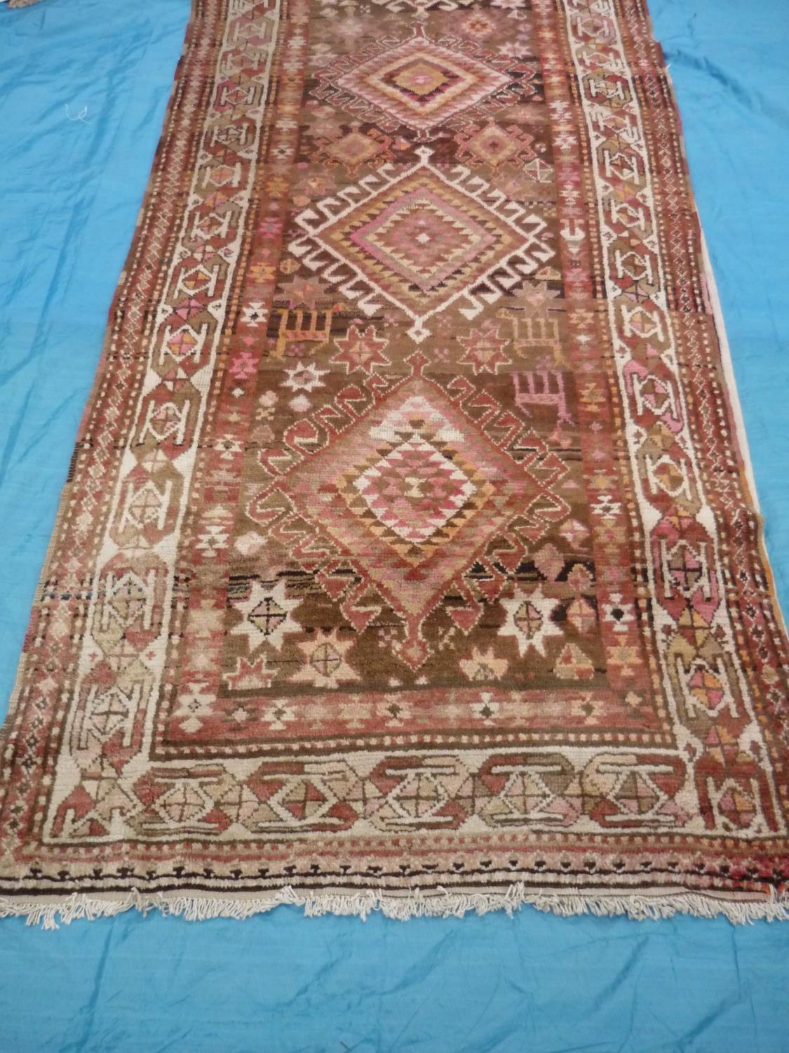 Long Persian type hand knotted rug with five central medallions (390cm x 125cm)