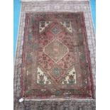 Small Persian type red ground rug (139cm x 100cm)