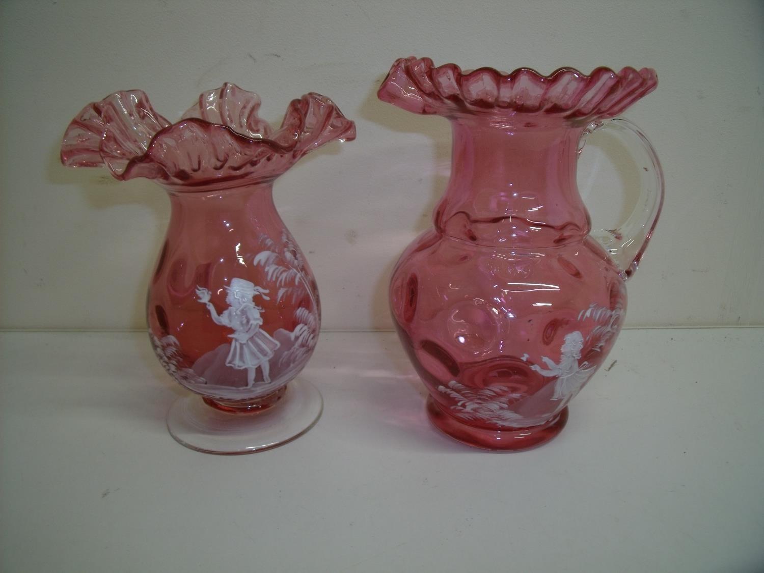 Mary Gregory style cranberry glass vases of bulbous form with frilled edge and a similar jug (18.5cm