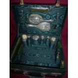 Leather travelling case by Z. Barraclough & Sons Leeds with green silk lined interior with various