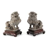 A pair of Chinese carved stone models of Buddhistic lions, probably 19th century, on later fitted
