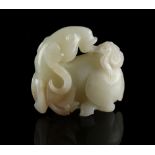 A 19th century Chinese carved pale celadon jade model of a recumbent goat with lingzhi in its mouth,