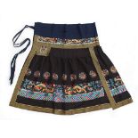 A good Chinese embroidered navy blue silk ceremonial apron or skirt, with dragons among clouds