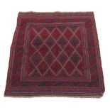 A Turkoman design rug with red ground, 47 by 45ins. (120 by 113cms.) (see illustration).