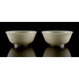 Property of a lady - a pair of Chinese carved white jade bowls, each finely carved with a band of
