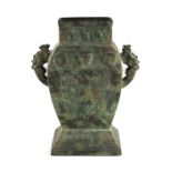 A Chinese archaistic bronze two-handled vase, of rectangular baluster form, 14.4ins. (36.5cms.) high