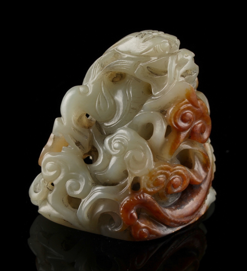 Property of a lady - a Chinese carved celadon & russet jade hat finial with a chilong among lingzhi,