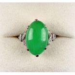 A platinum jadeite & diamond ring, the untreated oval cabochon jadeite measuring approximately 17.