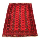 A Lori woollen hand-made rug with red ground, 71 by 39ins. (180 by100cms.) (see illustration).