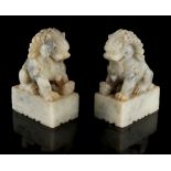 A pair of Chinese carved soapstone models of Buddhistic lions, early 20th century, each 4.9ins. (