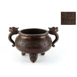 A large Chinese bronze tripod censer with gui dragon handles, apocryphal Xuande 6-character seal