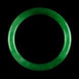 A Chinese jadeite bangle, of vivid apple green colour (see illustration).