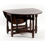 Property of a gentleman - an oak oval topped gate-leg table, with baluster turned supports, 43.