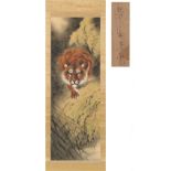 A Chinese scroll painting on silk depicting a prowling tiger, with calligraphy & red seal, the