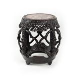 A good Chinese carved & pierced hongmu drum stool, late 19th century, with pink marble inset top,