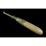 A carved & stained ivory model of a green gourd type vegetable, late 19th / early 20th century, 4.