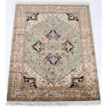 A Heriz style rug, with green ground, 75 by 55ins. (190 by 140cms.).