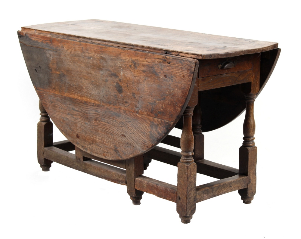 Property of a gentleman - an 18th century oak oval topped gate-leg dining table, with end drawer &