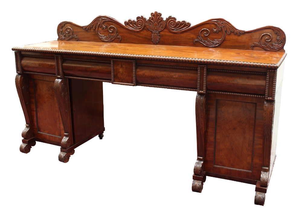 Property of a lady - a late Regency period mahogany twin pedestal sideboard, with carved low