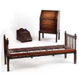 Property of a deceased estate - a 1920's oak barleytwist day-bed, 27.75ins. (70.5cms.) wide;