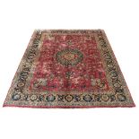A Meshed woollen hand-made carpet with red ground, 157 by 119ins. (400 by 302cms.) (see