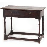 Property of a lady - an early 18th century oak side table with frieze drawer, on slender turned