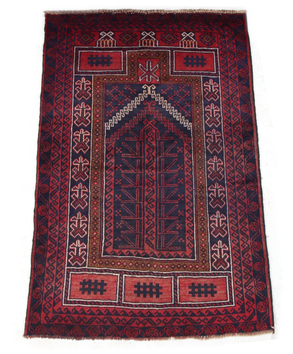 A Belouch rug with dark red ground, 59 by 36ins. (150 by 91cms.) (see illustration).